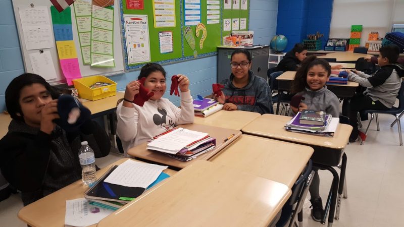 Warm Hearts, Warm Hands distributes hats and mittens to students at Dieterich Elementary